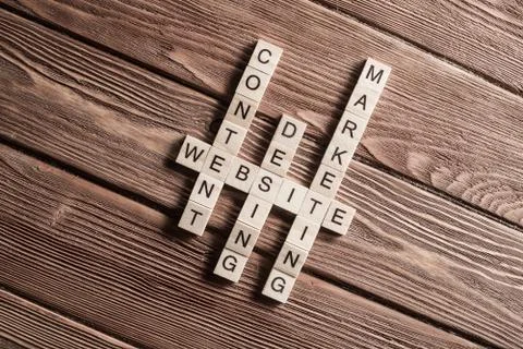Conceptual business keywords on table with elements of game making crossword Stock Photos
