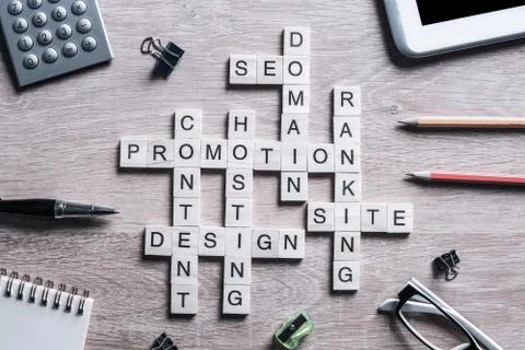 Conceptual business keywords on table with elements of game making crossword Stockfoto's