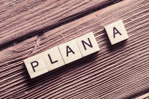 Conceptual business keywords on table with elements of game making words plan a Stock Photos