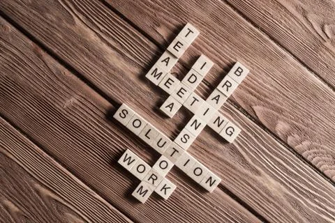 Conceptual business keywords on table with elements of game making crossword Stock Photos