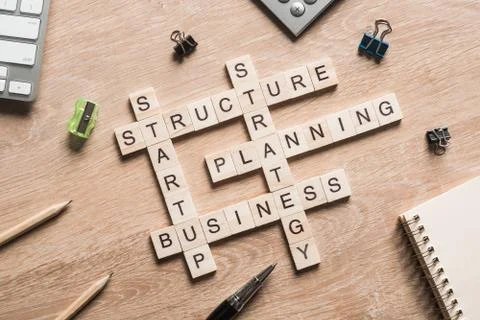 Conceptual business keywords on table with elements of game making crossword Stockfoto's