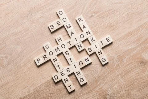 Conceptual business keywords on table with elements of game making crossword Stock Photos