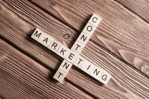 Conceptual business keywords on table with elements of game making crossword 库存照片