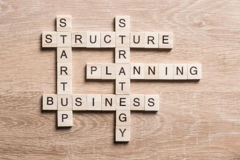 Conceptual business keywords on table with elements of game making crossword Stock Photos