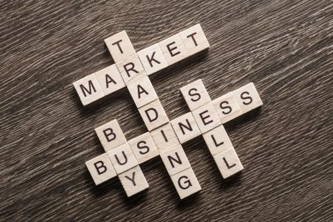 Conceptual business keywords on table with elements of game making crossword 库存照片