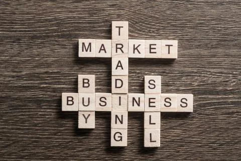 Conceptual business keywords on table with elements of game making crossword 库存照片