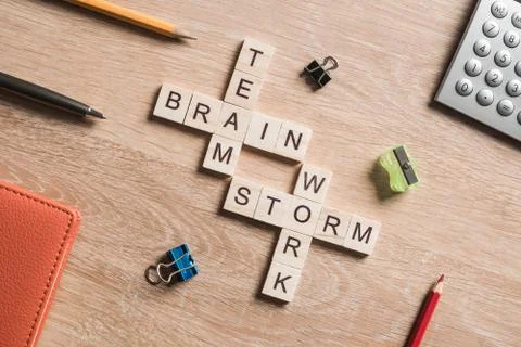 Conceptual business keywords on table with elements of game making crossword Stockfoto's