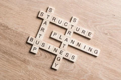 Conceptual business keywords on table with elements of game making crossword Stock Photos