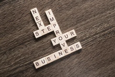 Conceptual business keywords on table with elements of game making crossword Stock Photos