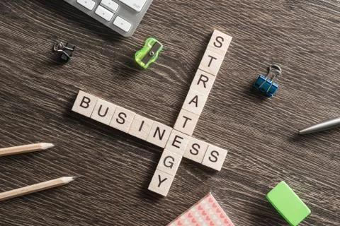 Conceptual business keywords on table with elements of game making crossword Stock Photos