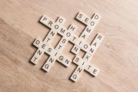 Conceptual business keywords on table with elements of game making crossword Foto stock