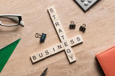 Conceptual business keywords on table with elements of game making crossword Stock Photos