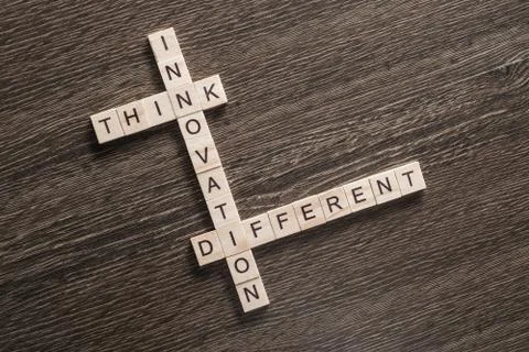 Conceptual business keywords on table with elements of game making crossword 库存照片