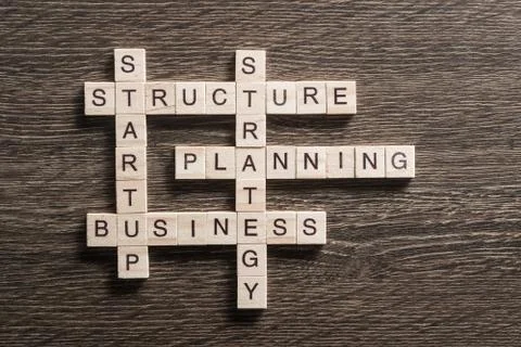 Conceptual business keywords on table with elements of game making crossword Stock Photos