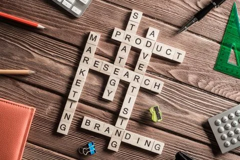 Conceptual business keywords on table with elements of game making crossword Stock Photos