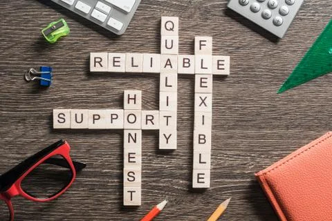 Conceptual business keywords on table with elements of game making crossword Foto stock