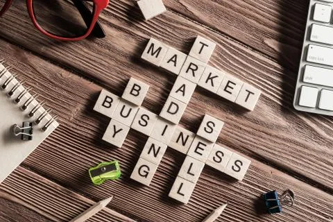 Conceptual business keywords on table with elements of game making crossword Stock Photos