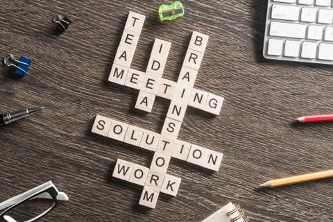 Conceptual business keywords on table with elements of game making crossword Foto stock