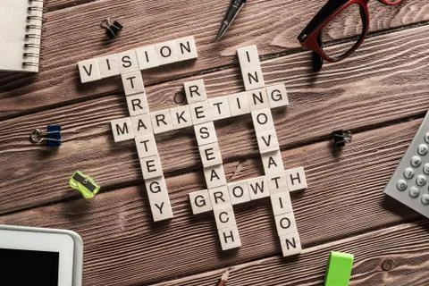 Conceptual business keywords on table with elements of game making crossword 스톡 사진
