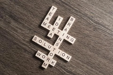 Conceptual business keywords on table with elements of game making crossword Foto stock