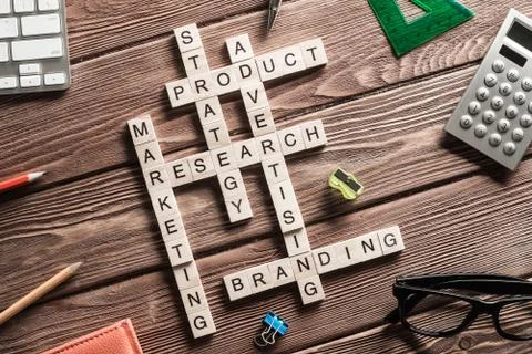 Conceptual business keywords on table with elements of game making crossword Stock Photos