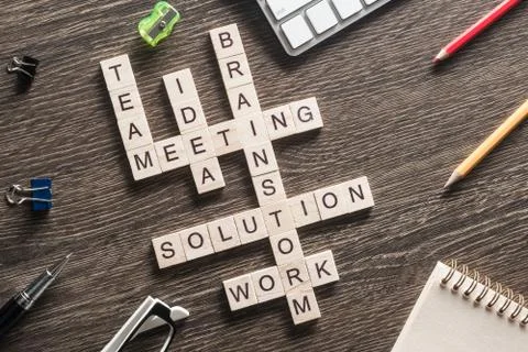 Conceptual business keywords on table with elements of game making crossword Foto stock