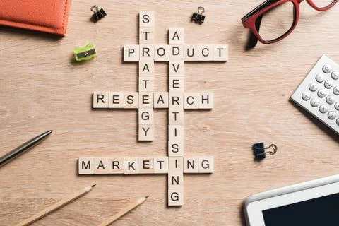 Conceptual business keywords on table with elements of game making crossword Stock Photos