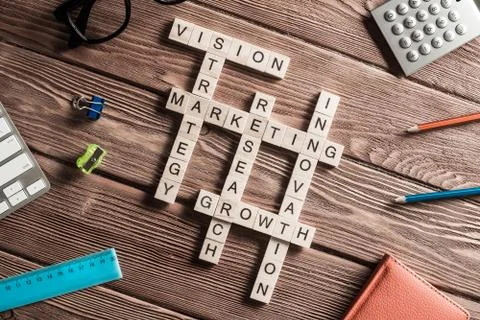 Conceptual business keywords on table with elements of game making crossword Stock Photos