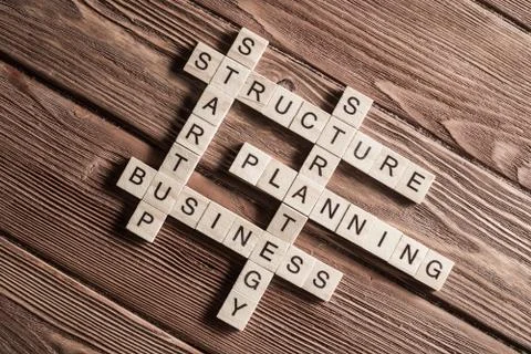 Conceptual business keywords on table with elements of game making crossword Stock Photos