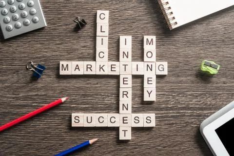 Conceptual business keywords on table with elements of game making crossword Stockfoto's