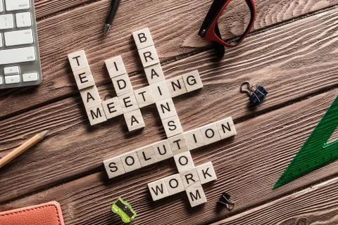 Conceptual business keywords on table with elements of game making crossword Stock Photos
