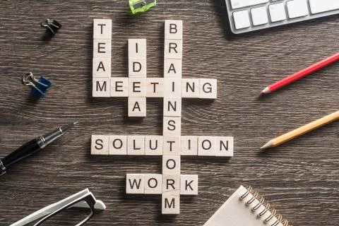 Conceptual business keywords on table with elements of game making crossword Stock Photos