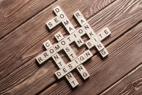 Conceptual business keywords on table with elements of game making crossword Stock Photos