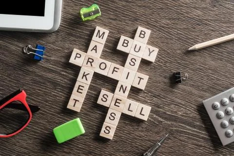 Conceptual business keywords on table with elements of game making crossword Stockfoto's