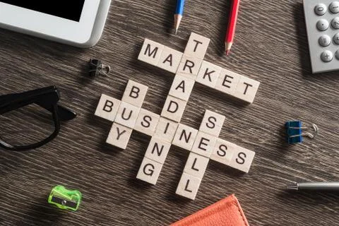 Conceptual business keywords on table with elements of game making crossword Stock Photos