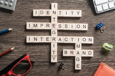 Conceptual business keywords on table with elements of game making crossword Stock Photos