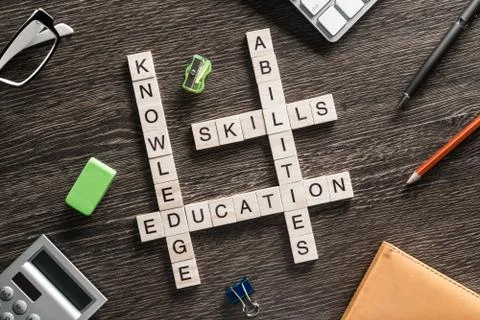 Conceptual business keywords on table with elements of game making crossword Stock Photos