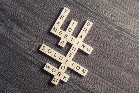Conceptual business keywords on table with elements of game making crossword Stock Photos