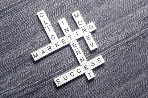 Conceptual business keywords on table with elements of game making crossword Stock Photos