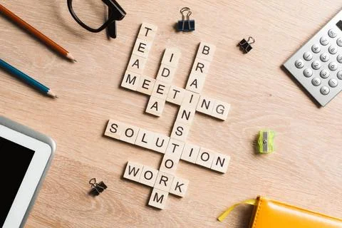 Conceptual business keywords on table with elements of game making crosswo... Stock Photos