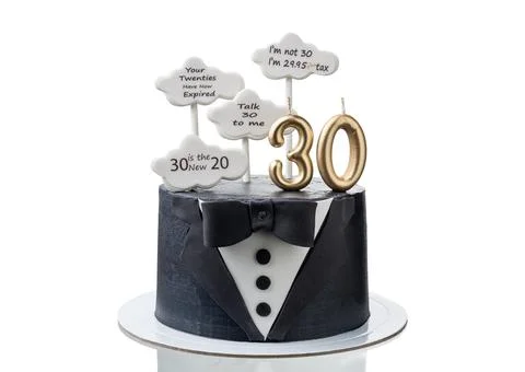 Conceptual cake in form of a tuxedo suit for an anniversary and a cloud with Stock Photos