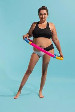 Conceptual collage with young plus-size woman with slender legs doing exercises Foto stock