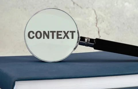 Conceptual context symbol. Copy space. Context word written through a magnify Stock Photos