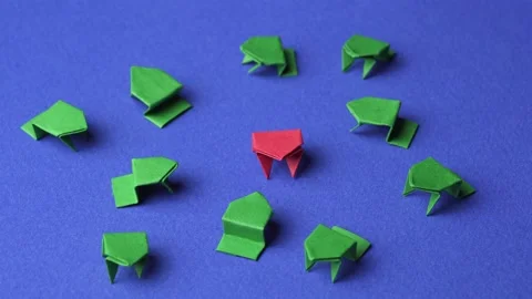Conceptual discrimination, leadership, or difference. Origami paper frogs Video stock 162075319