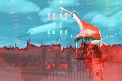 Conceptual double exposure image of a red fuel pump nozzle at gas station ove Stock Photos