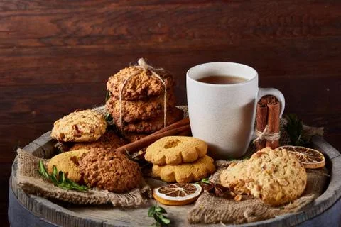 Conceptual festive composition with a cup of hot tea, cookies and spicies on a Stock Photos