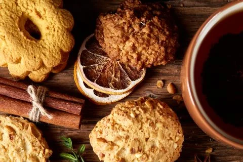 Conceptual festive composition with a cup of hot tea, cookies and spicies on a Stock Photos