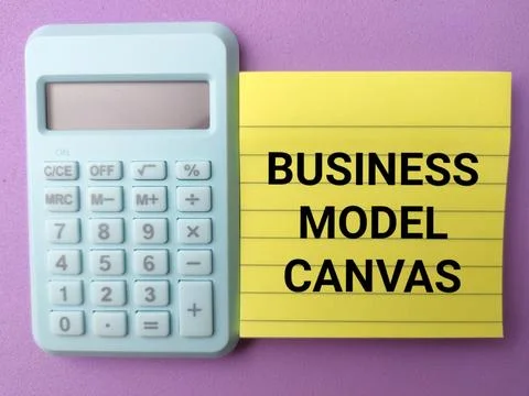Conceptual flat lay featuring the text BUSINESS MODEL CANVAS on a yellow st.. Stock Photos