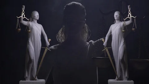 Conceptual footage of Themis statue with blindfold on her face, sword and scales Stock Footage
