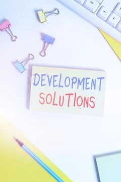 Conceptual hand writing showing Development Solutions. Business photo showcasing Stock Photos